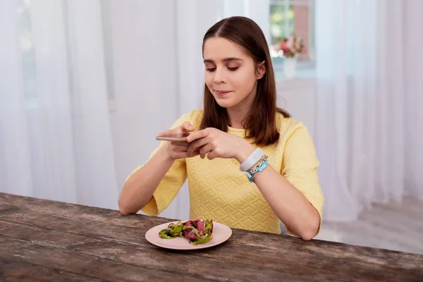 Cunning teen blogger saving photo — Stock Photo, Image