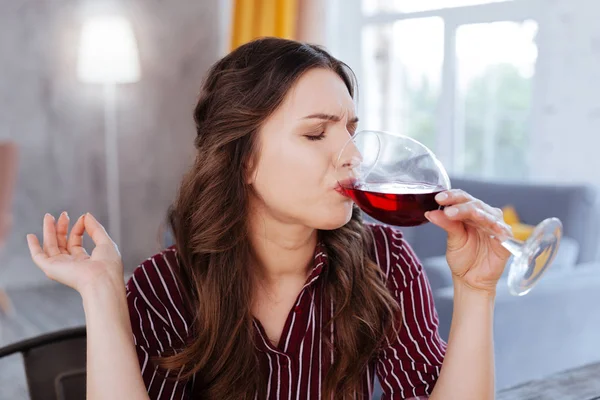 Dark-haired woman drinking wine after stress — Stock Photo, Image