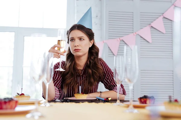 Woman feeling pessimistic at birthday party — Stock Photo, Image