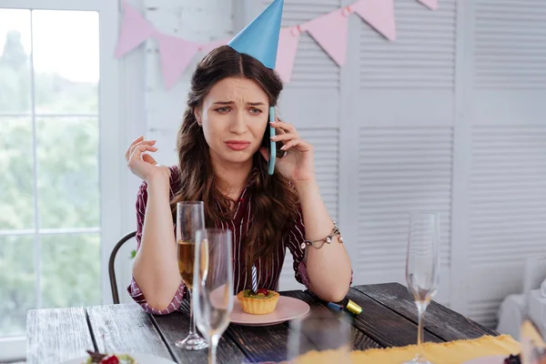 Emotional woman calling her guests on birthday — Stock Photo, Image