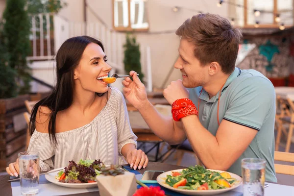 Sonriente mujer radiante sintiéndose feliz sentado cerca de hombre cariñoso — Foto de Stock