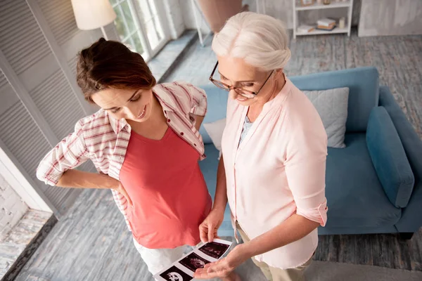 Retied doctor looking at ultrasound investigation — Stock Photo, Image