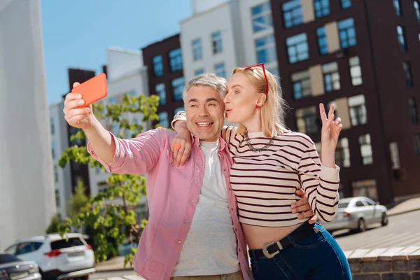 Delighted joyful couple taking photos — Stock Photo, Image