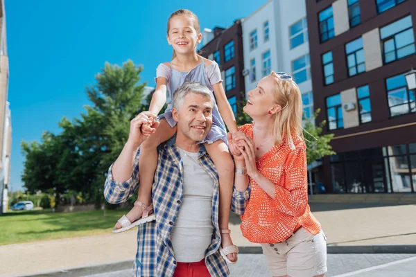 Onun babaları omuzlarında oturan hoş mutlu kız