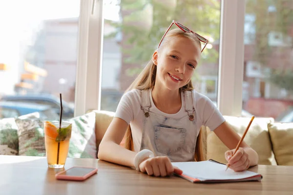 Young smiling artist holding pencil in her hand — Stock Photo, Image