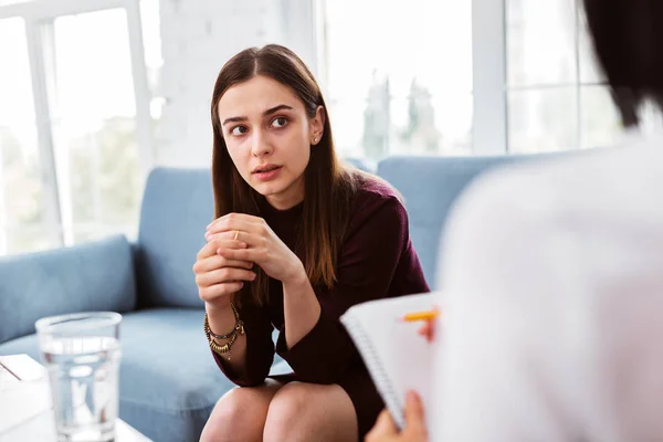 Expressive woman looking at the psychologist and changing her mind — Stock Photo, Image