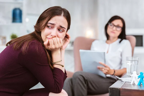 Upset woman turning her head while visiting a psychologist — Stock Photo, Image