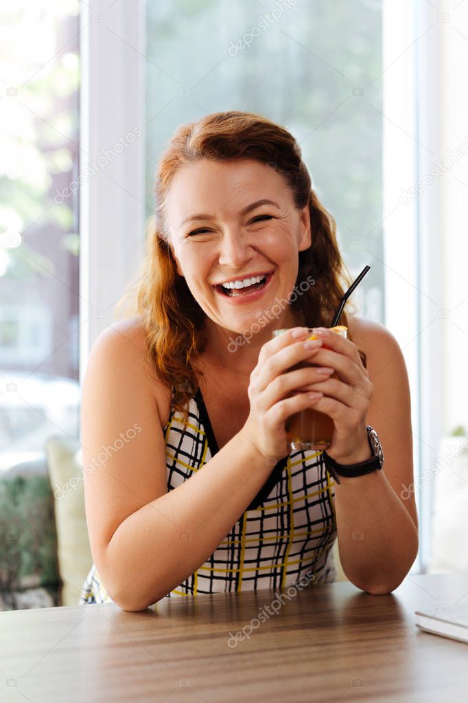 Happy mature woman laughing while communicating with husband