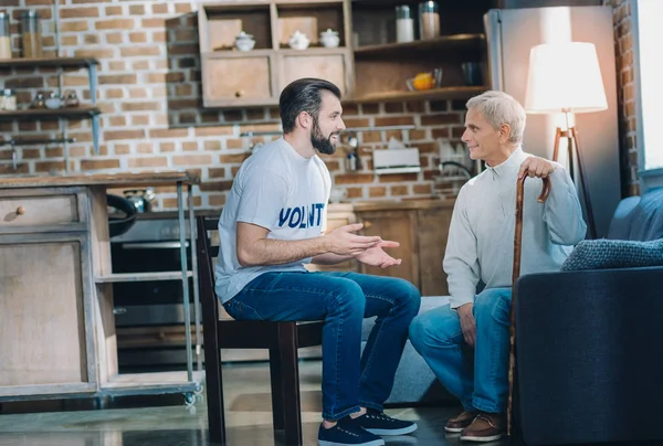 Nice happy man talking with an aged man