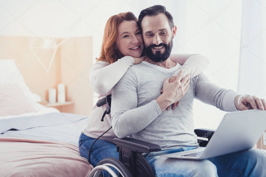 Emotional couple smiling and dreaming about living in a comfortable house
