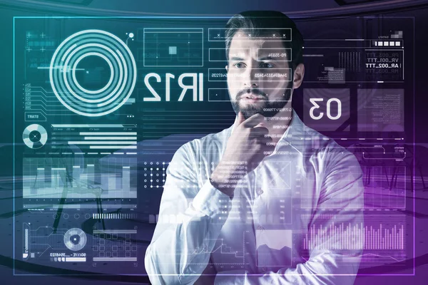 Clever employee touching his beard and thoughtfully looking at the screen — Stock Photo, Image