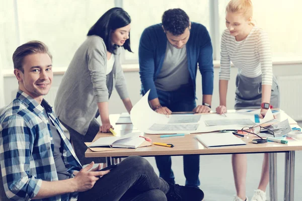 Handsome blonde sitting in semi position in office — Stock Photo, Image