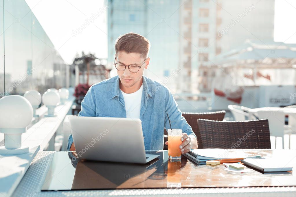 Attentive brunette man working with computer