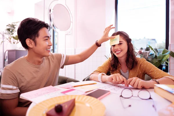 Dark-haired smiling student having fun with girlfriend — Stock Photo, Image