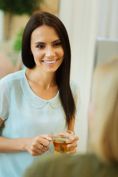 Attractive nice woman holding a cup of tea — Stock Photo, Image