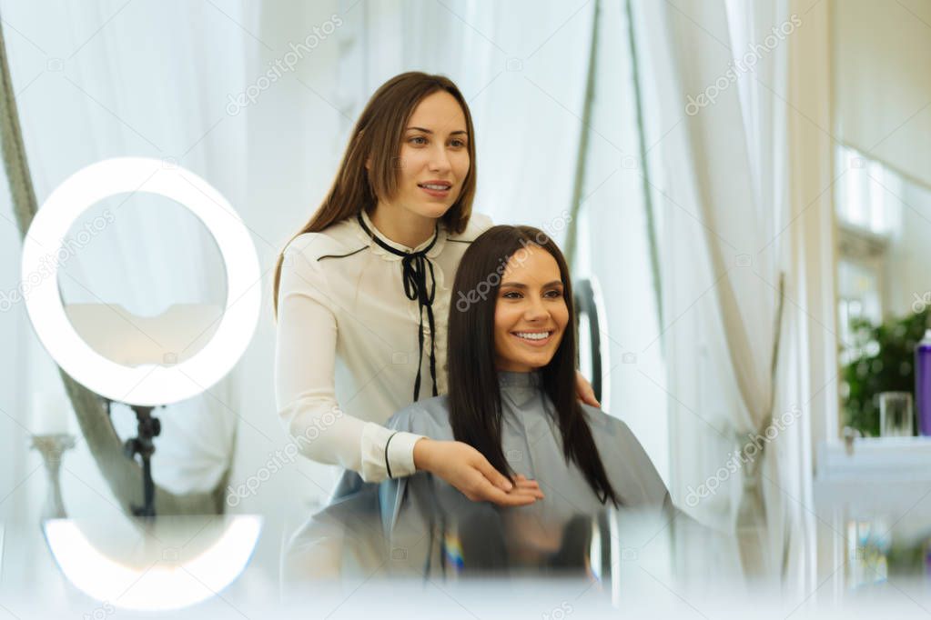 Positive joyful woman talking to her client