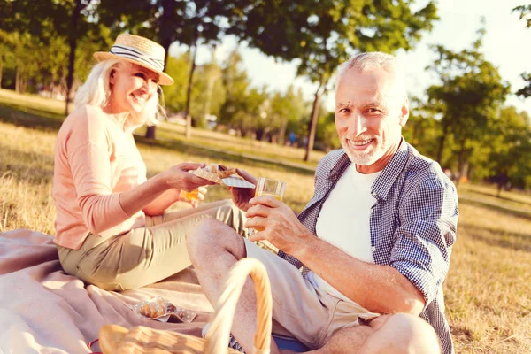 Cheerful retired family enjoying picnic together — Stock Photo, Image