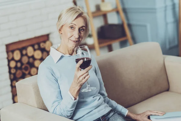 Расслабленная блондинка пьет вино — стоковое фото