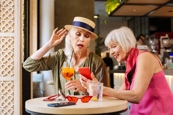 Nice aged women sitting at the table — Stock Photo, Image