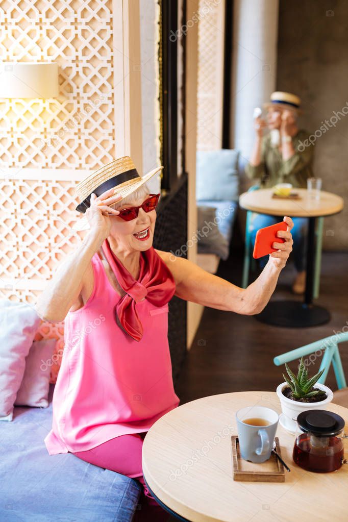 Delighted nice woman visiting a cafe