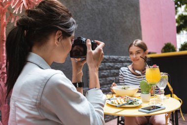 Profesyonel kamera tutarak şık saç modeli ile esmer kadın