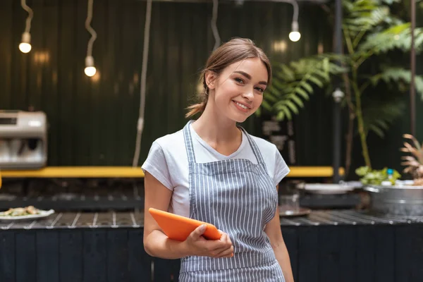 Mooie serveerster verwelkomen gasten van restaurant — Stockfoto