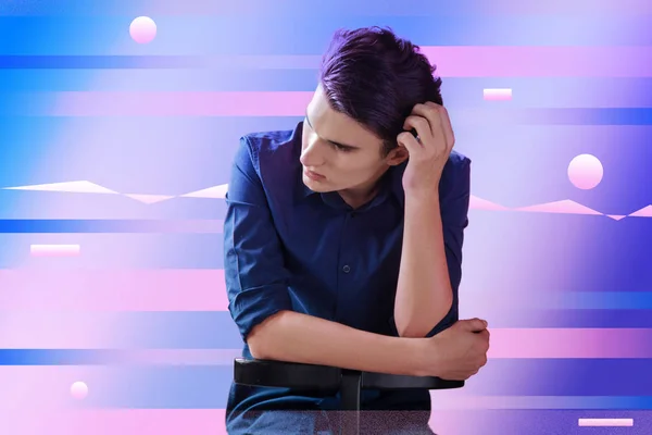 Young man touching his head and looking worried — Stock Photo, Image