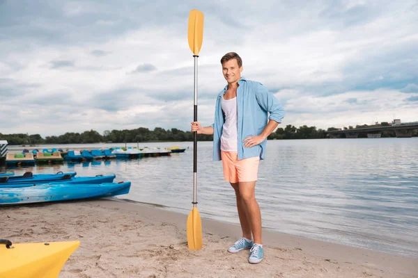 Handsome beaming businessman being fond of river sport — Stock Photo, Image