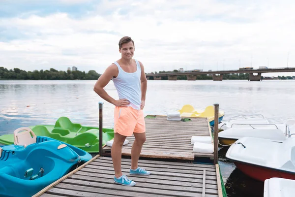 Smiling strong man standing ashore preparing for river ride — Stock Photo, Image