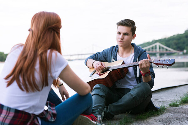 Pleasant nice man holding the guitar Romantic date.