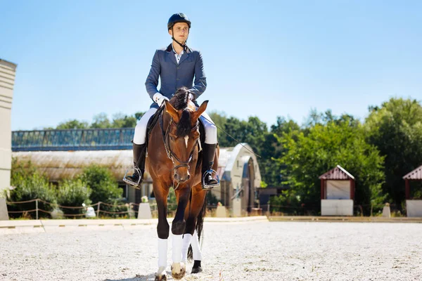 Young promising equestrian training on big spacious race track — Stock Photo, Image