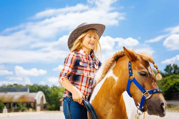 Cute smiling cowboy girl leading little beautiful pony — Stock Photo, Image