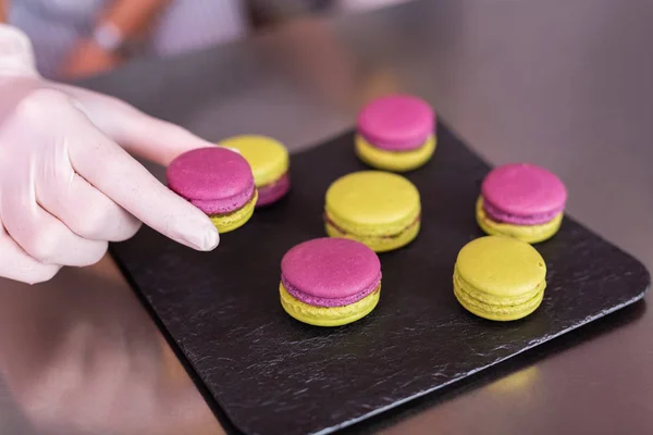 Profesyonel pudra macaroons holding beyaz eldivenler — Stok fotoğraf