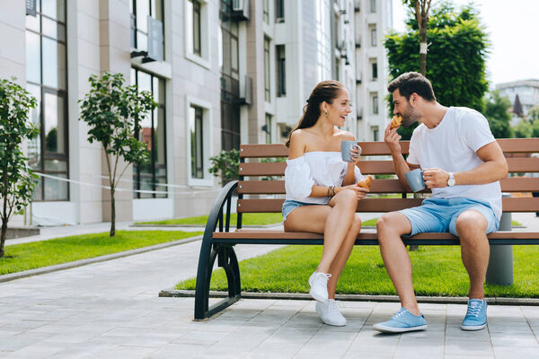 Delighted nice couple enjoying their lunch