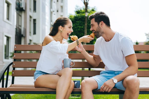 Happy positive couple feeding each other — Stock Photo, Image