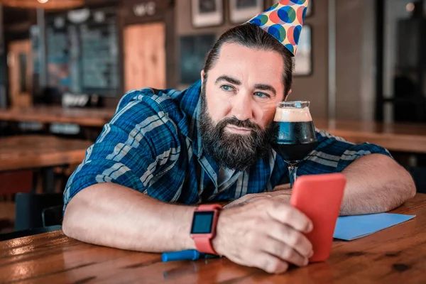 Strong muscle man feeling very depressed on birthday — Stock Photo, Image