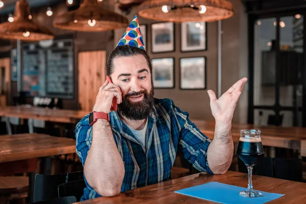 Birthday man feeling very emotional while speaking on the phone