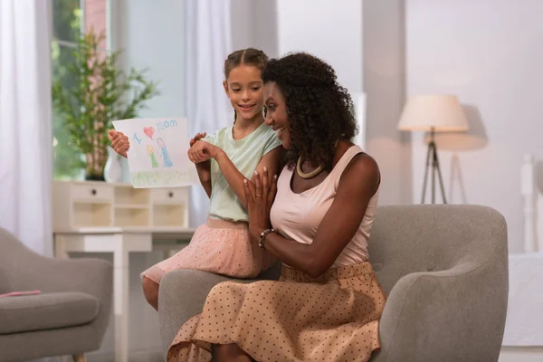 Happy delighted woman enjoying the drawing of her daughter — Stock Photo, Image