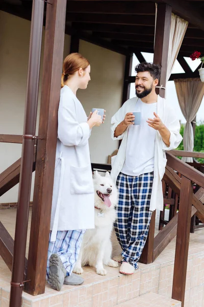 Bearded husband talking to his wife in the morning