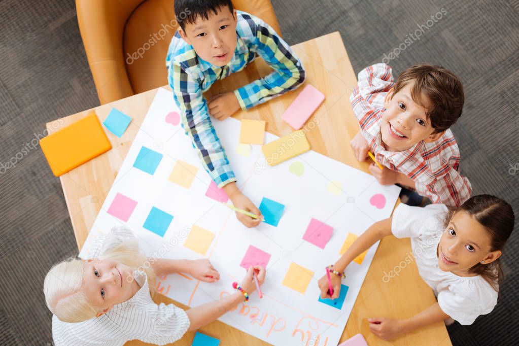 Funny joyful children looking above all together