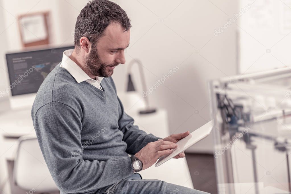 Handsome adult man sitting at the office