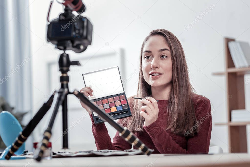 Attractive woman telling about new eye shadows