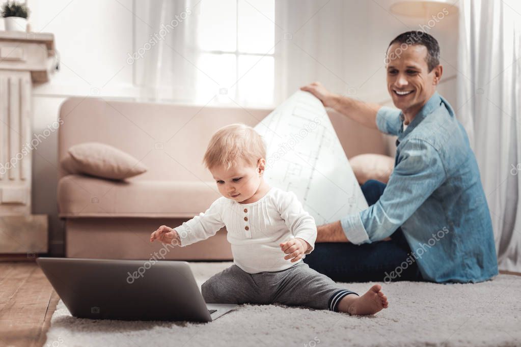 Smart cute baby looking at the laptop screen