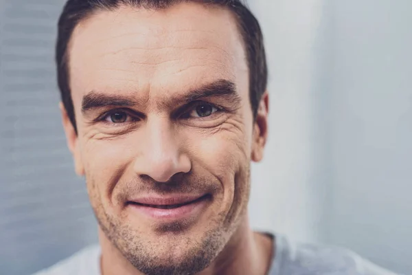 Hazel-eyed handsome man smiling while looking at beloved — Stock Photo, Image