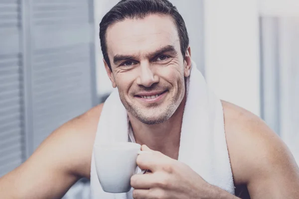 一杯のコーヒーを保持している楽観的な男 — ストック写真