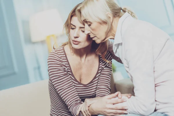 Nice aged woman comforting her daughter