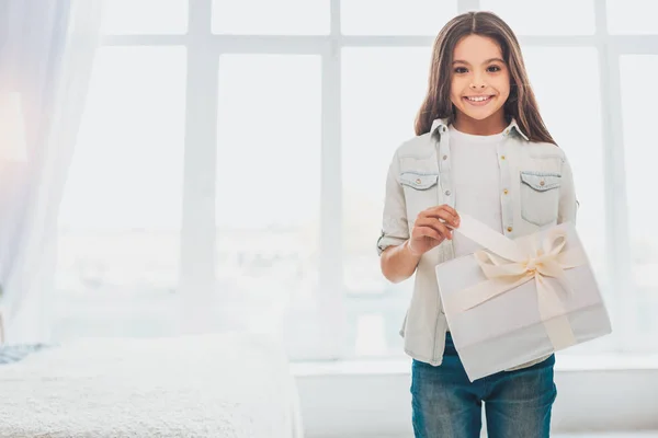 Appealing child standing near big light window — Stock Photo, Image