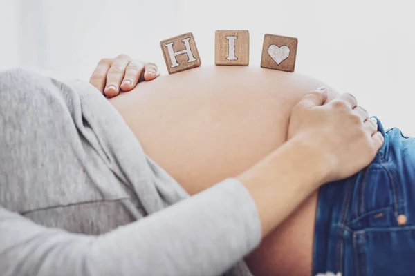 Close up of pregnant woman stroking her belly — Stock Photo, Image