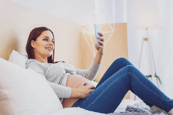 Mujer embarazada alegre haciendo una selfie — Foto de Stock