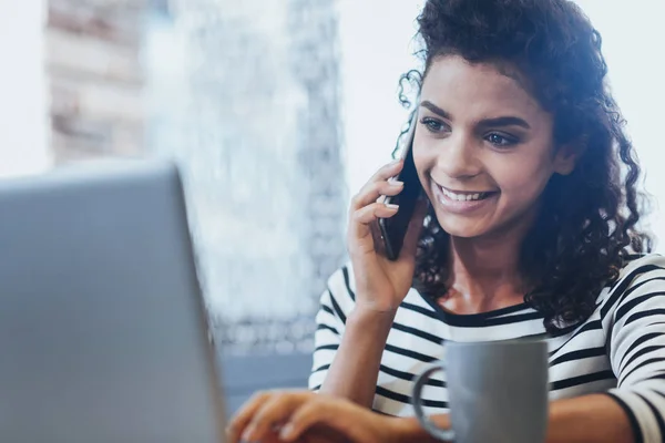 Jovial female freelancer calling employer — Stock Photo, Image